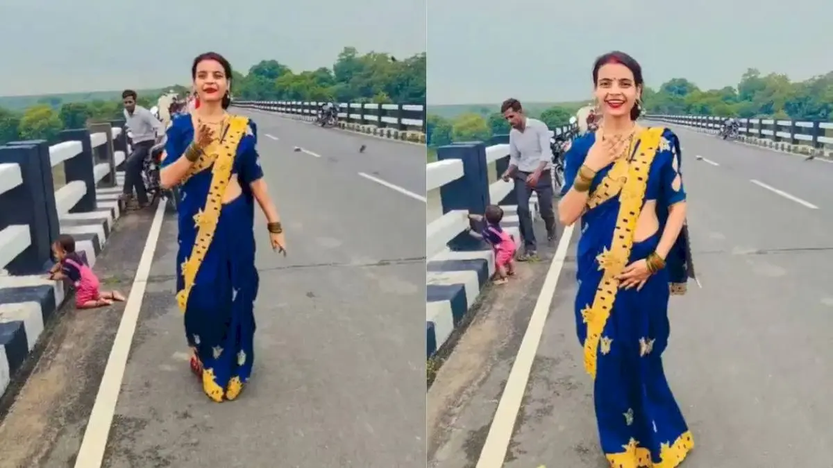 Baby crawls toward bridge edge as woman films reel, stranger intervenes