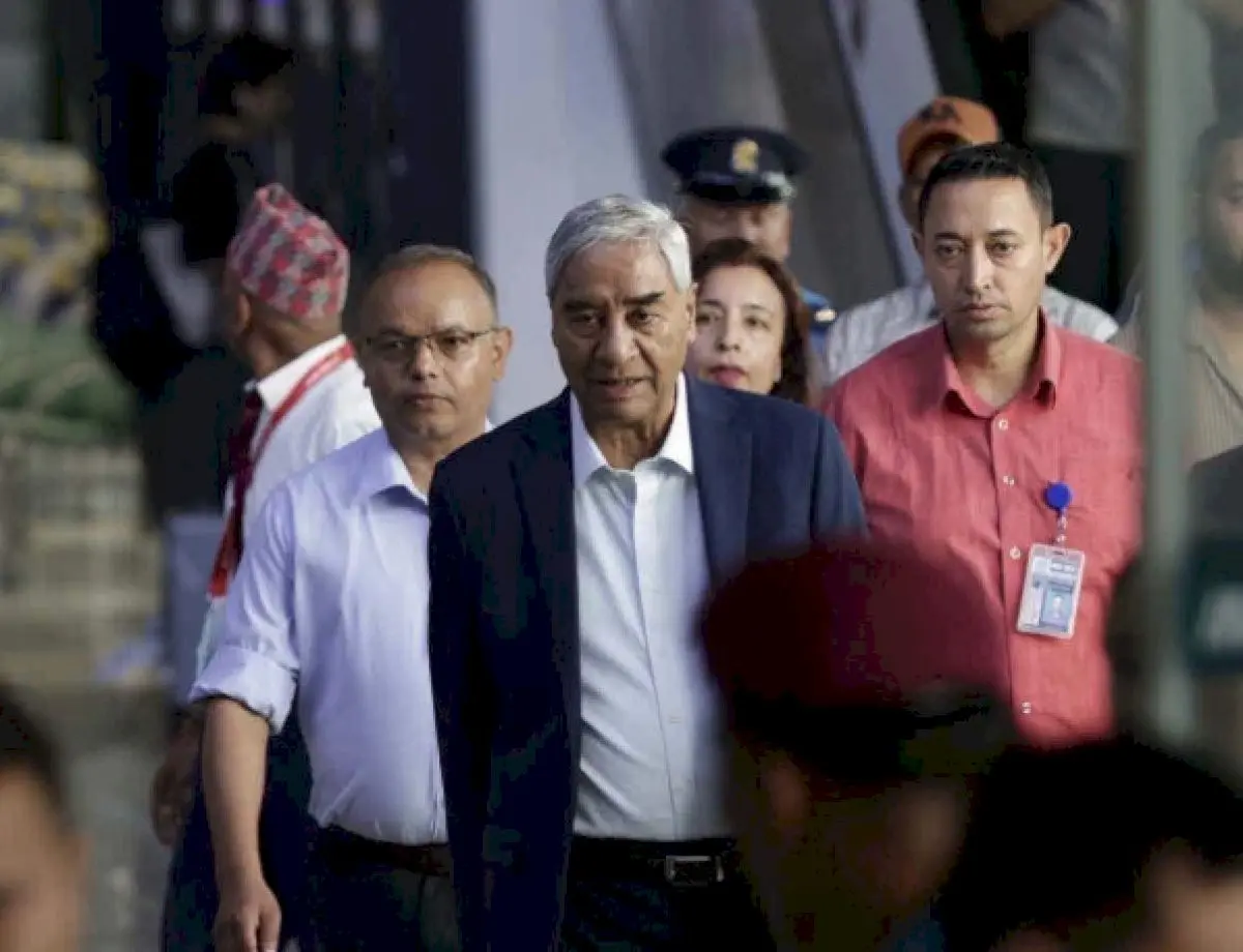 Former Nepal PM Deuba returns amid money-laundering probe