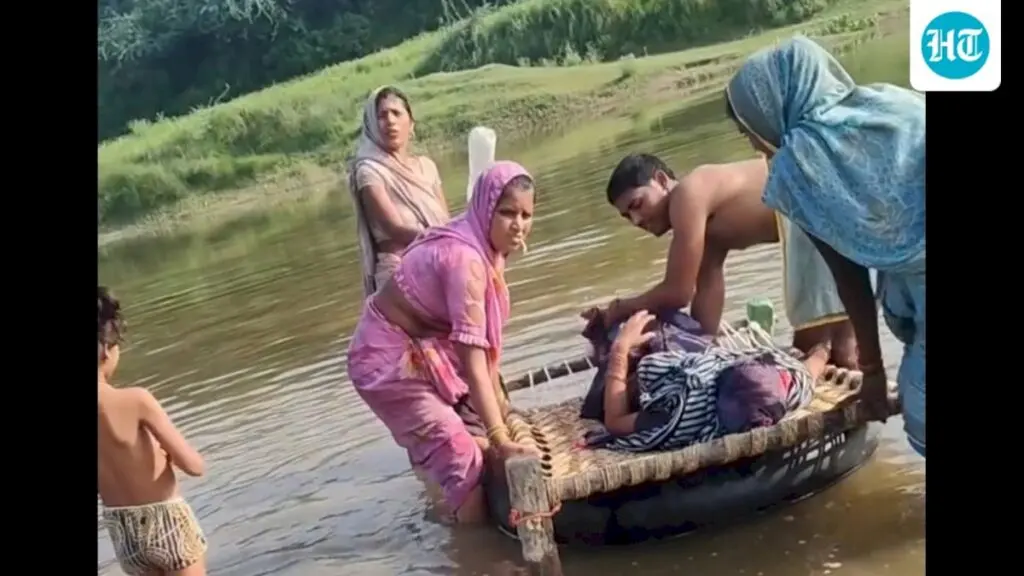 Woman, newborn carried across flooded Utangan river on cot float