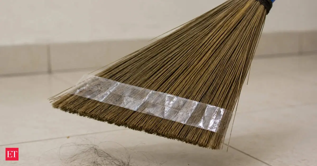 Simple cleaning hack uses tape on broom to collect debris